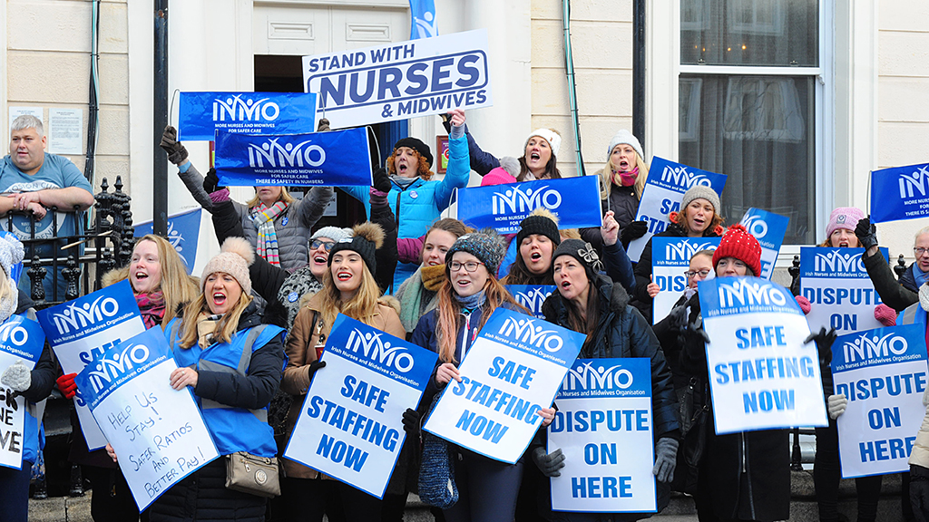 group of nurses holding safe staffing signs